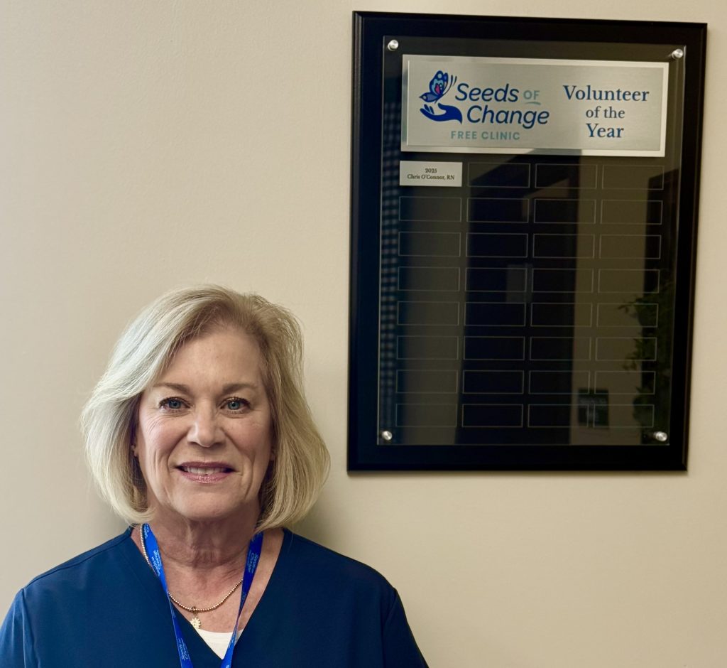 Chris O'Connor standing next to her award